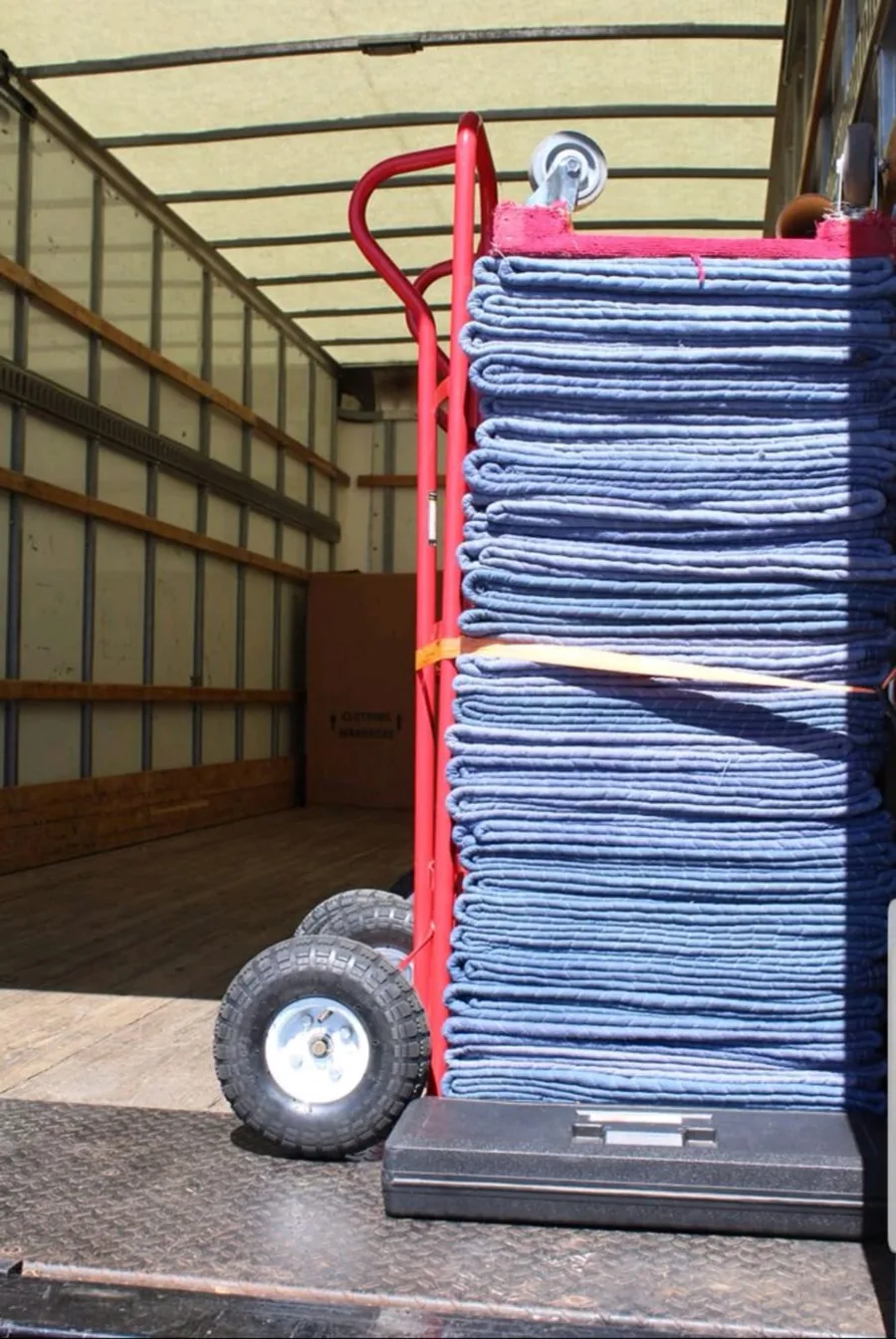 Moving blankets and dollies prepared inside truck