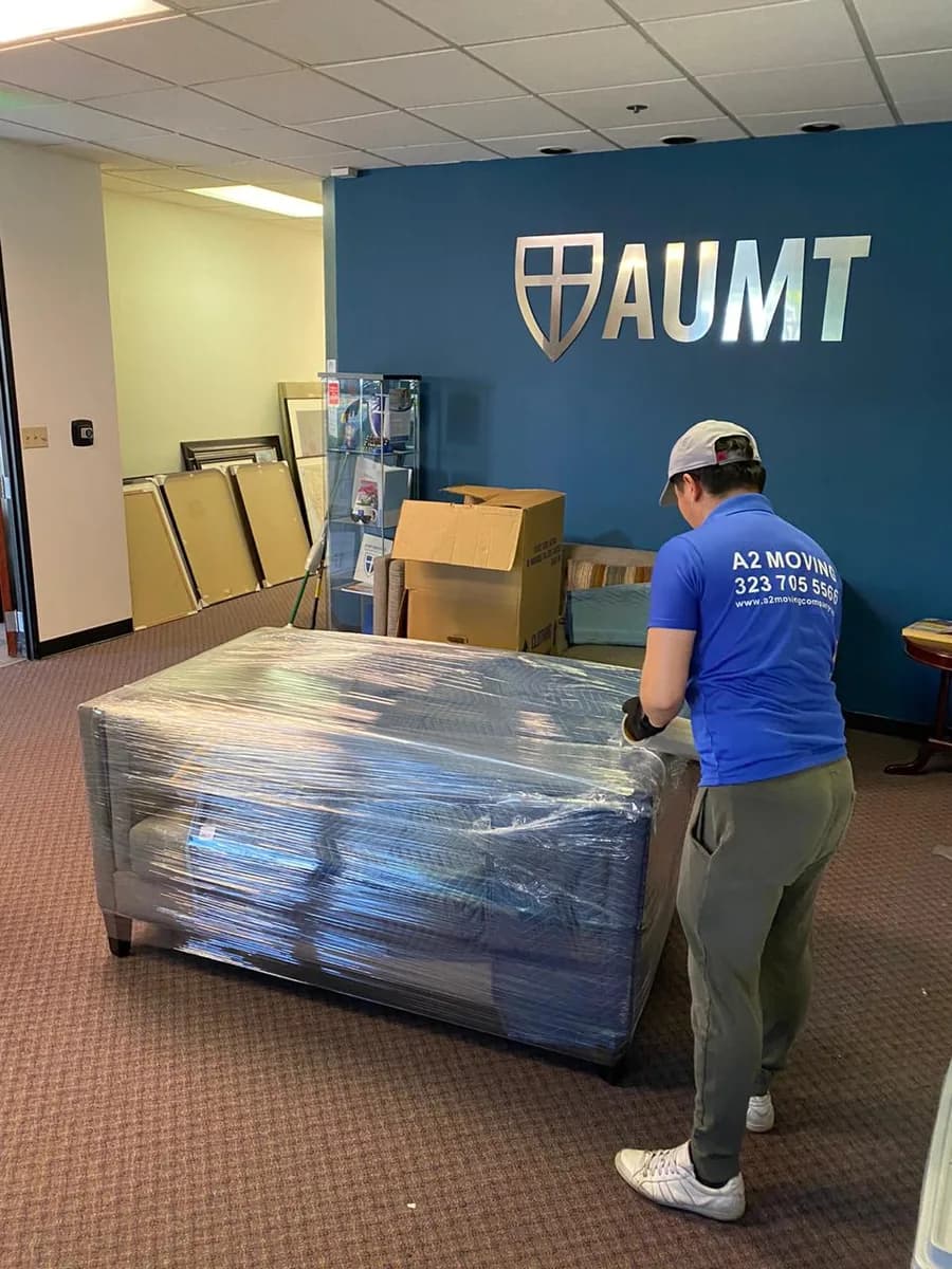 A2 Moving crew wrapping office furniture